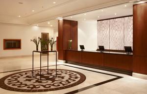 a lobby with a reception area with a reception desk at Hyatt Regency Bishkek in Bishkek