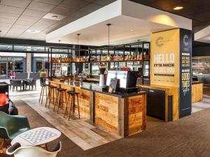 a bar in a restaurant with a counter and stools at ibis Bristol Centre in Bristol