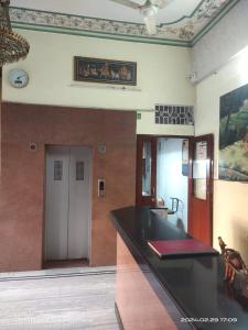 a kitchen with a black counter top in a room at Hotel Surbhi palace in Jaipur