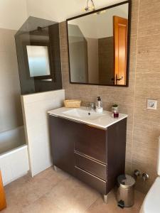 a bathroom with a sink and a mirror at Hostal Espai Mediterrani in Puebla de Vallbona