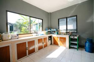 a kitchen with a sink and a window at Nadee House in Ban Pa Sang (1)