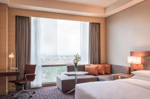 a hotel room with a bed and a desk at Hyatt Regency Lucknow Gomti Nagar in Lucknow