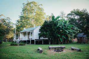 a white house with a picnic table in front of it at Gheerulla Place in Gheerulla