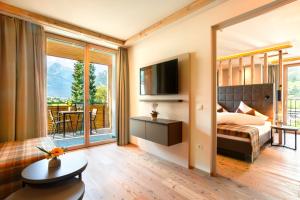 a hotel room with a bed and a balcony at Alpin Apartments in Mayrhofen