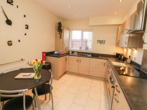 a kitchen with a table and a dining room at 9 Seaford Sands in Paignton