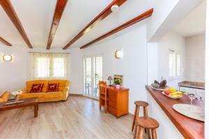 a living room with a yellow couch and a table at Villa Santa Lucia in Denia