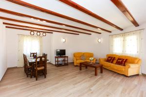 a living room with a couch and a table and chairs at Villa Santa Lucia in Denia