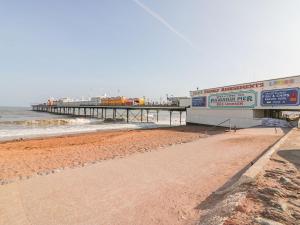 a pier on the beach next to the ocean at 9 Seaford Sands in Paignton