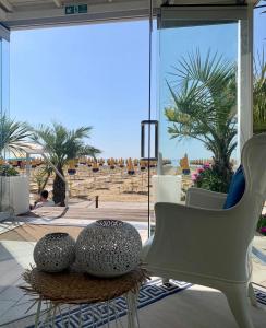 a room with a chair and a table with balls on it at Hotel Nizza Frontemare Superior 3 Stelle in Lido di Jesolo +80 photos