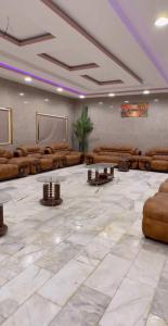 a large room with couches and a projection screen at شاليه السلوى in Hafr Al Baten