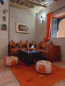 a living room with a couch and a table at Riad Ain Khadra in Taroudant