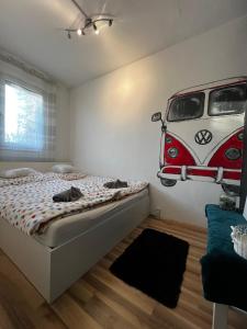 a bedroom with a bed with a van on the wall at Renapartman in Pécs