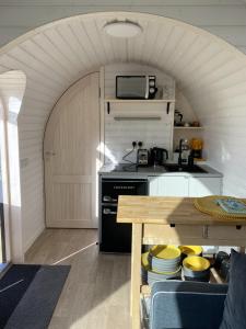 a kitchen with a stove and a counter top at Jam First - Lydcott Glamping, Cornish Sea Views in East Looe