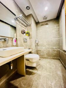 a bathroom with a toilet and a sink at Hotel NASHA Unit By Worth New Delhi in New Delhi