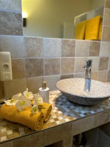 a bathroom with a sink and a counter top with a sink at Ferienwohnung Welle OG in Fehmarn