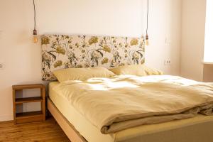 an unmade bed in a bedroom with a curtain at Kotič na hribu in Dobravlje +11 photos