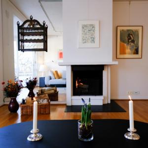 a living room with two candles and a fireplace at Cosy Apartment in Frogner in Oslo