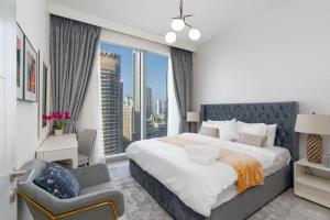 een slaapkamer met een groot bed en een groot raam bij Mystic - Forte Tower 2 in Dubai