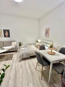 a bedroom with a bed and a table and chairs at Apartment Robin - Old Town in Bratislava