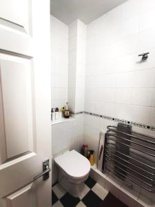 a bathroom with a toilet and a black and white floor at Charming apartment with big terrace in Sandymount in Dublin