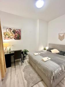 a bedroom with a bed and a desk and a table at Apartment Robin - Old Town in Bratislava