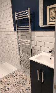 a bathroom with a sink and a shower at Duporth Guest House in Penzance