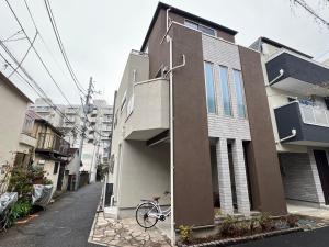 a bike is parked next to a house at Shinjuku House in Tokyo