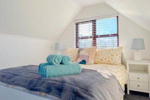 a bedroom with a bed with two towels on it at Snug, Dog Friendly, Country Cottage in Worle