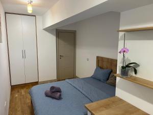 a bedroom with a bed with two pillows on it at 2 rooms apartment Airy & Bright Chic in Iaşi