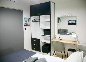a bedroom with a desk and a bedroom with a bed at Mikel Angelo hall in Serres