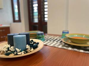 a plate of blue candles on a wooden table at EtnaMare petite maison in Mascali