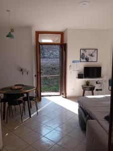 a bedroom with a bed and a table and a door at Casa Sogno Como in Como