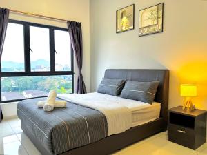 a bedroom with a bed and a large window at The Horizon Ipoh by Yan's Home - Sky Infinity Pool in Ipoh