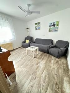 a living room with a couch and a table at Rioja Villa by Wave Properties in Arrúbal