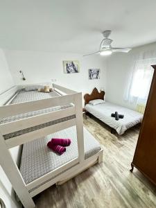 two bunk beds in a room with pink socks at Rioja Villa by Wave Properties in Arrúbal