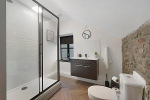 a bathroom with a shower and a toilet and a sink at Unicorn House Hot Tub Near Barnard Castle in Barnard Castle +38 photos