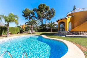 a swimming pool in front of a villa at Villa Santa Lucia in Denia