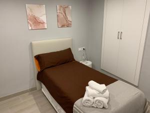 1 dormitorio con 1 cama con toallas en Casa José Morella, en Morella