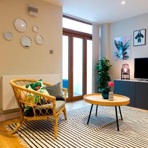 un soggiorno con sedia e tavolo di Madison Hill - Byrne Garden 3 - One bedroom home a Londra