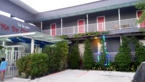 a building with a christmas tree in front of it at Mo Do Ong in Ubon Ratchathani