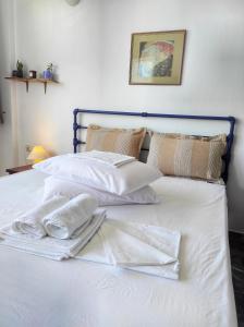a white bed with towels on top of it at Dimitra's in Amarynthos