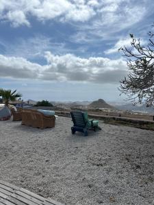 Casa Rural El Pasil في أرونا: كرسي أخضر جالس فوق حقل حصى