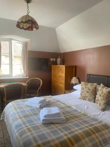 1 dormitorio con 1 cama con toallas en The Steam Packet, en Littlehampton