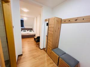 a room with a closet and a bedroom with a bed at Kozjanski dvor in Podčetrtek