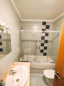a bathroom with a shower and a sink and a tub at The Lookout in Areia Branca +47 photos