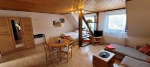 a living room with a couch and a table at Haus Zehnthof in Burgen