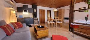 a kitchen and a living room with a couch and a table at Haus Zehnthof in Burgen