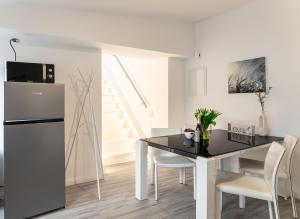 a kitchen and dining room with a table and a refrigerator at Haus Himmelglück - Fewo Himmel mit Terrasse & 2 Schlafzimmer in Zinnowitz