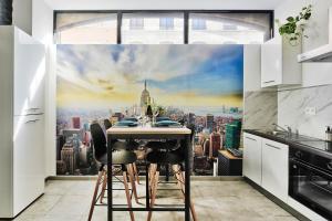 a kitchen with a table with a view of the city at Le somptueux saint-clair in Caluire-et-Cuire