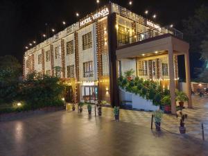 a large building with lights on it at night at Hotel Vrinda in Maihar